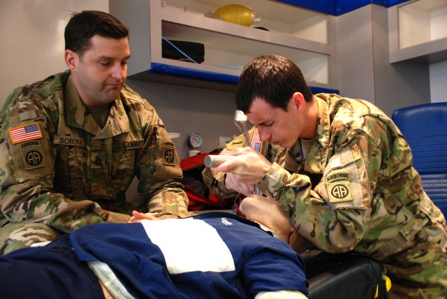 military-medic.jpg Staff Sgt. James Soroka, left, and Sgt. Brandon Dukes, both medics assigned to the 82nd Combat Aviation Brigade practice endotracheal intubation, March 3, 2016. Both Soldiers are attending paramedic training at Fayetteville Technical Community Col. (Photo Credit: U.S. Army)