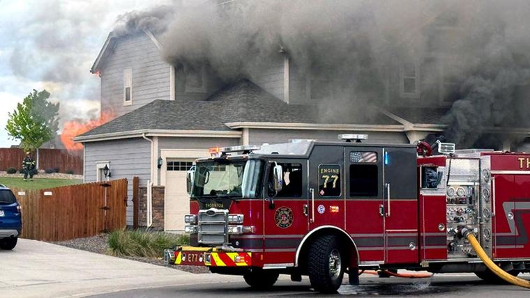 A fire engine at the scene of a working structure fire